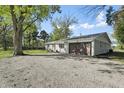 Single-story home featuring a two-car garage, landscaped yard, and mature trees at 2956 N 700 E, Franklin, IN 46131
