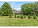 Inviting home featuring a well-manicured lawn, mature trees, and a welcoming facade at 3631 S 450 E, Whitestown, IN 46075