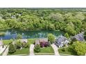 Serene aerial view of houses surrounded by lush greenery and a tranquil lake at 3708 Gould Dr, Carmel, IN 46033