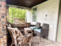 Inviting front porch with comfortable wicker and cushioned seating offering an outdoor relaxation space at 3745 Winthrop Ave, Indianapolis, IN 46205