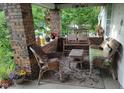 Cozy front porch with wicker chairs, a bench swing, and decorative details at 3745 Winthrop Ave, Indianapolis, IN 46205