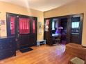 Inviting living room features hardwood floors, dark trim, and views into an office space and the front entrance at 3745 Winthrop Ave, Indianapolis, IN 46205