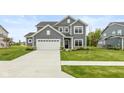Well-maintained two-story home with gray siding, white trim, and a spacious driveway at 3980 Railhead Ave, Westfield, IN 46074