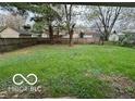 Expansive backyard featuring lush green grass and a wooden privacy fence at 4108 Steinmetz Dr, Indianapolis, IN 46254
