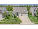 A beautiful aerial view of the house with a well-maintained lawn and driveway at 4428 Maldenhair Dr, Indianapolis, IN 46239