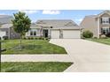 Charming single-story home with a well-manicured lawn and a two-car garage at 4428 Maldenhair Dr, Indianapolis, IN 46239