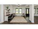 Bright foyer with stylish rug, black framed windows and doors, and a built-in desk at 4457 E County Road 850 N, Pittsboro, IN 46167