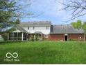 Expansive backyard with a screened porch and brick exterior at 4667 Sundance Trl, Indianapolis, IN 46239