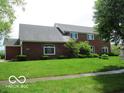 Well-maintained two-story brick home with arched windows and a lush green lawn at 4667 Sundance Trl, Indianapolis, IN 46239