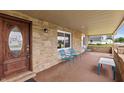 Inviting front porch with stone accents, comfortable seating, and a beautifully designed front door at 521 Sunset Dr, Edinburgh, IN 46124