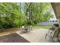 Cozy backyard patio with seating, surrounded by lush greenery for a private outdoor retreat at 5988 White Birch Dr, Fishers, IN 46038