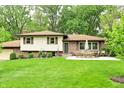 Landscaped home exterior with a patio and outdoor dining set at 6126 Rucker Rd, Indianapolis, IN 46220