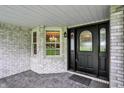 Inviting front porch featuring detailed trim work and an elegant glass front door at 6190 S 425 W, Pendleton, IN 46064