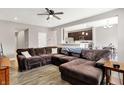 Spacious living room with a large sectional sofa, ceiling fan, and hardwood floors at 6463 Wasco Dr, Whitestown, IN 46075