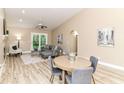 Cozy living room featuring vaulted ceilings, a gray sofa, and abundant natural light at 6471 Hunters Green Pl, Indianapolis, IN 46278