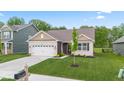 Beautiful single-Gathering home, landscaped lawn, a brick facade and an attached garage at 6609 Dunkirk Dr, McCordsville, IN 46055