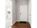 Bright foyer featuring wood floors, white walls, and an entry to another room at 6609 Dunkirk Dr, McCordsville, IN 46055