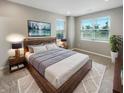 Relaxing bedroom with large windows, a comfortable bed, and stylish decor at 6847 Cardiff Dr, McCordsville, IN 46055