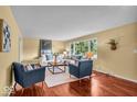 Bright living room with ample seating, hardwood floors, and natural light from large windows at 7316 Lesley Ave, Indianapolis, IN 46250