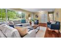 Inviting living room with large windows, a comfortable couch, and stylish decor at 7316 Lesley Ave, Indianapolis, IN 46250