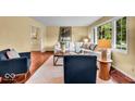Cozy living room featuring comfortable seating and a large window with natural light at 7316 Lesley Ave, Indianapolis, IN 46250