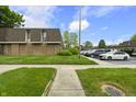 Townhome exterior showcasing well-maintained grounds, parking, and brick construction at 7334 Country Brook Dr, Indianapolis, IN 46260