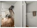 Bright interior view highlighting staircase with hardwood floors, and bathroom entrance at 7334 Country Brook Dr, Indianapolis, IN 46260