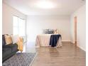Bright bedroom features contemporary design, a large window, wood-look floors, and a door to the closet at 8317 Pine Branch Ln, Indianapolis, IN 46234