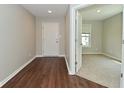 Entryway with wood-look floors and a view to a carpeted bedroom with natural light at 8354 Fieldfare Way, Indianapolis, IN 46237