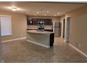 Spacious kitchen with stainless steel appliances, a center island with a sink, and tile flooring at 8354 Fieldfare Way, Indianapolis, IN 46237