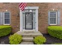 Inviting front entrance with a decorative door, sidelights, and manicured landscaping, enhancing curb appeal at 8430 Harrison Pkwy, Fishers, IN 46038