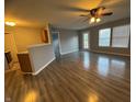 Open-concept living room with hardwood floors, neutral paint and ample natural light and ceiling fan at 9145 Blue Pine Dr, Indianapolis, IN 46231