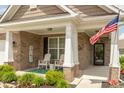 Inviting front porch with rocking chairs, 'Welcome' sign, and American flag at 9166 Lieven St, Avon, IN 46123