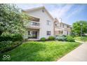 Apartment exterior with a balcony, a sliding glass door, and verdant landscaping at 931 Wickham Ct # 101, Carmel, IN 46032