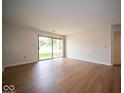 Bright living room with wood floors and a sliding glass door to outdoor space at 931 Wickham Ct # 101, Carmel, IN 46032