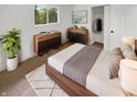 Cozy bedroom with natural light features neutral colors, hardwood furnishings, closet, and a plush area rug at 9490 E 36Th Pl, Indianapolis, IN 46235
