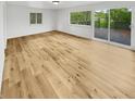 Light-filled empty room featuring hardwood floors and large sliding glass doors at 9490 E 36Th Pl, Indianapolis, IN 46235