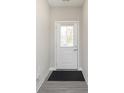 Bright entryway featuring a front door with a window and neutral-toned walls and flooring at 9570 Beckett St, Avon, IN 46123