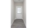 Hallway with gray vinyl floors leading to an exterior door with glass at 9583 Beckett St, Avon, IN 46123