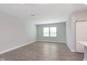 Open-concept living room featuring neutral walls and gray vinyl floors at 9583 Beckett St, Avon, IN 46123