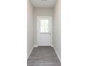 Bright entryway featuring grey wood floors and a white front door at 9604 Beckett St, Avon, IN 46123