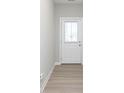 Bright entryway featuring luxury vinyl plank flooring and a modern white door with glass insert at 9652 Beckett St, Avon, IN 46123