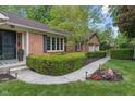 Inviting front entrance with a brick facade, a charming walkway, and manicured landscaping at 9885 Oakleaf Way, McCordsville, IN 46055
