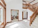 Spacious foyer with tile flooring, wood trim, and staircase leading to the second level at 10350 Courageous Dr, Indianapolis, IN 46236