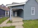 Gray two-story home featuring a covered porch and horizontal siding at 1322 S Belmont Ave, Indianapolis, IN 46221
