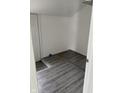 Empty room showcasing gray wood-look flooring and white walls and trim at 1322 S Belmont Ave, Indianapolis, IN 46221