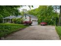 Exterior view of house featuring a garage, basketball hoop, and well-manicured lawn at 13300 Fairwood Dr, McCordsville, IN 46055