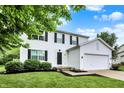 Charming two-story home with a well-manicured lawn and attached two-car garage at 14638 Deerwood Dr, Carmel, IN 46033