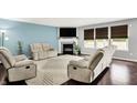 Bright living room featuring cozy seating, a fireplace, and ample natural light at 14638 Deerwood Dr, Carmel, IN 46033