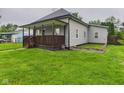 Well-maintained home with a spacious yard and covered porch, perfect for outdoor living at 1520 E Kirk St, Muncie, IN 47303